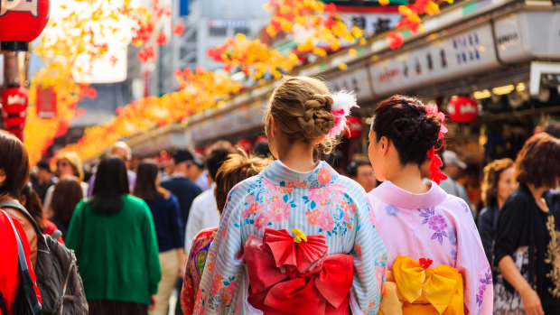 Tourists wear kimonos in Tokyo.