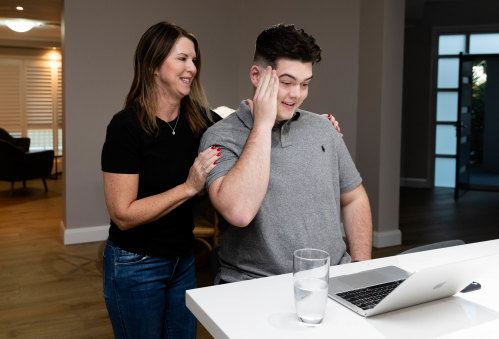 Flynn Broom, with his mother, Katie Broom, gets his HSC results on Friday morning. 