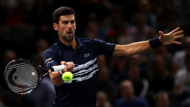 Novak Djokovic of Serbia returns a forehand in his semi-final against Grigor Dimitrov in Paris.