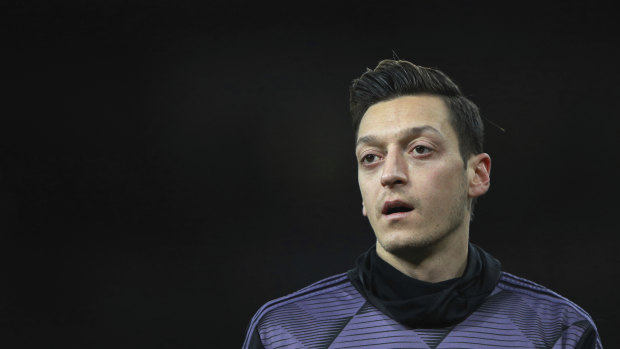 Arsenal's Mesut Ozil warms up prior the English Premier League soccer match between Arsenal and Manchester City, that was pulled off Chinese TV.