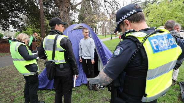 Police talk to protesters in Carlton Gardens.
