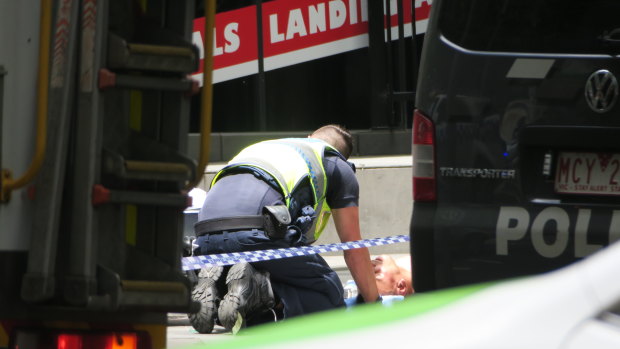 A police officer talks with Gargasoulas after the rampage.