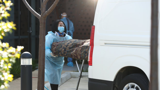 A body is removed from Epping Gardens aged care home in Melbourne in July.