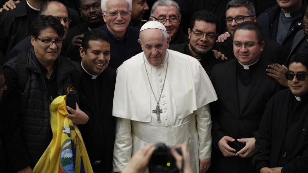 Pope Francis poses for a picture with priests during the weekly general audience at the Vatican on Wednesday.
