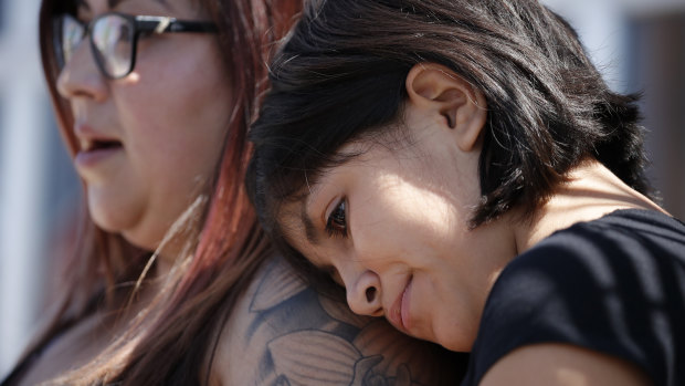 Eleven-year-old Leilani Hebben puts her head on her mother Anabel Hebben's shoulder as they visit the scene of a mass shooting at a shopping centre in El Paso, Texas.