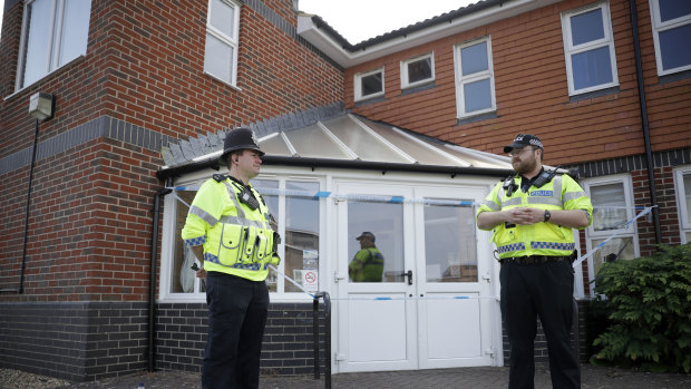 British police officers guard a cordon outside the Amesbury Baptist Centre on Wednesday.  