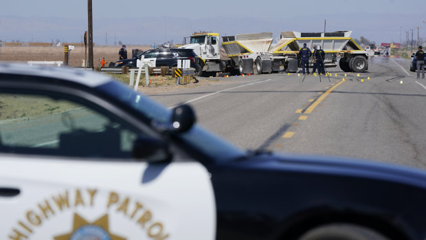 Law enforcement officers work at the scene of a deadly crash in California.