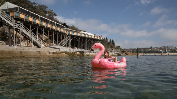 Summer McGuiggan, 7, riding her inflatable flamingo at Wylie's Baths in Coogee.