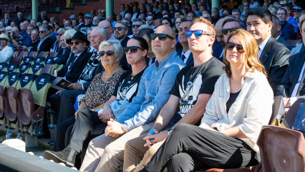 Raudonikis’ wife Trish Brown, far left, and family watch the service.