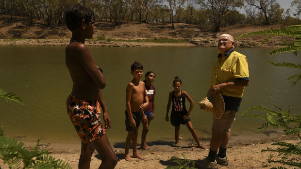 Barkandji elder Kevin Knight, right, talks to Indigenous youth from Bourke, Laithan Rocher, 12, Aaron McKellar, 12, Sharika McKellar, 13, and Shekia Edwards, 12, about the significance of the Darling River to Indigenous communities.