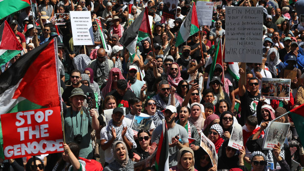 Palestine supporters gather during a protest at Town Hall on October 21, 2023 in Sydney, Australia.