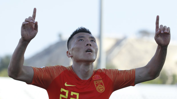 Clincher: Chinese defender Yu Dabao celebrates scoring his side's winner against Asian Cup minnows Kyrgyzstan.