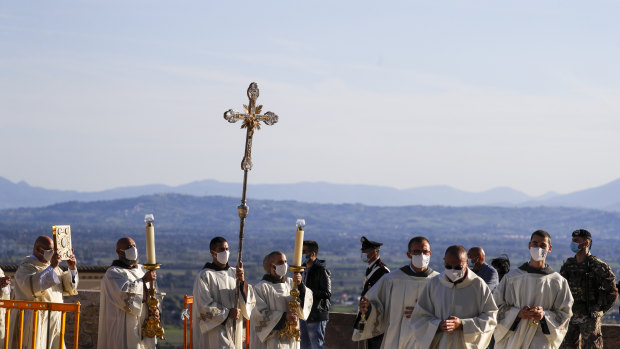 A procession walks through the streets of Assisi, Italy, prior to the beatification ceremony of 15-year-old Carlo Acutis.