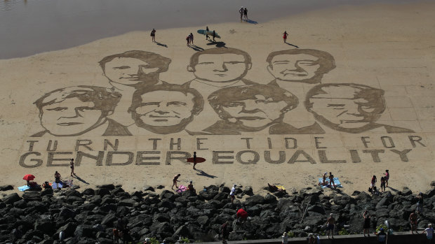 A portrait of G7 leaders is drawn into the sand over the headline 'Turn the tide for Gender Equality' in Biarritz, France, ahead of the 2019 summit.