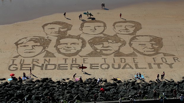 A portrait of G7 leaders is drawn into the sand over the headline 'Turn the tide for Gender Equality' in Biarritz, France, ahead of the 2019 summit.