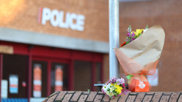Flowers are left outside the Henderson Police station after an officer was killed on Friday.