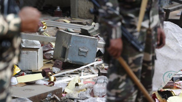 A safe of a shop lie outside after it was ransacked during riots in Delhi, India.