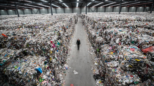 Carly Whitington walks through her company's Derrimut warehouse, which is filled with recyclable waste put there by insolvent company SKM.