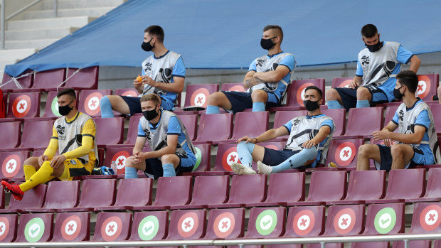 Sydney FC’s substitutes sit in the stands, socially distanced, at Doha’s Khalifa International Stadium late last year.