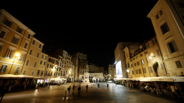 People leave Rome's Campo dei Fiori before the start of curfew. Italian Premier Giuseppe Conte has been leaving it up to regional governors to order restrictions such as overnight curfews, including in Naples.