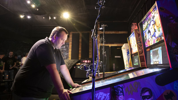 Richard Rhodes competes in the finals of the pinball championship at Belconnen.
