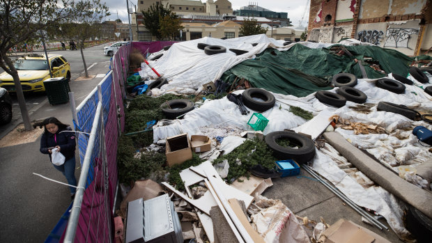 Two and a half years after the Corkman was razed, the site is still full of rubble covered with tarpaulins and old tyres.