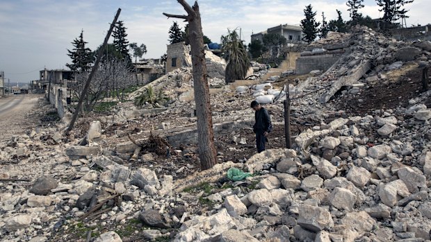 A man visits the site of an attack that killed at least 36 Turkish soldiers last month in Balyoun, Syria.