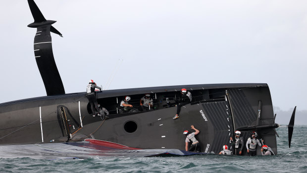 American Magic crew try to stop the boat sinking after it capsized in race two against Prada Luna Rosa 1during the 2021 PRADA Cup Round Robins on Auckland Harbour on January 17, 2021 in Auckland, New Zealand. 