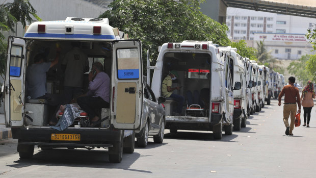 Ambulances line up waiting for their turn to deliver patients to a dedicated COVID-19 hospital in Ahmedabad, India.
