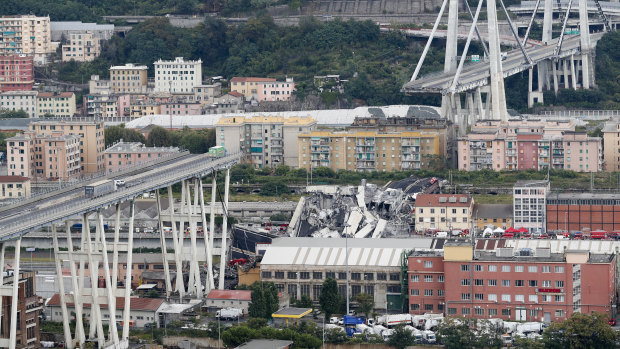 Cars stop on the Morandi highway bridge after a section of it collapsed on August 14, 2018.