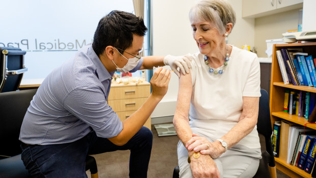 Dr Chris Lee vaccinates a Phase 1b patient at Lindfield Medical Practice on Monday.