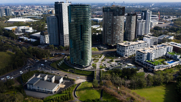 The evacuation of the Opal Tower, in the foreground, two years ago due to cracking led to a shake up of building regulations. 