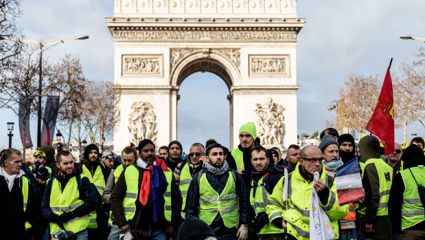 Destined for a museum ... protesters wearing yellow vests in front of the Arc de Triomph in Paris.