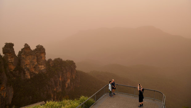  Tourists at the Three Sisters lookout in Katoomba last November as fire conditions  continued. 