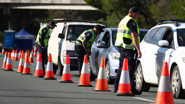 Police stop vehicles at the Queensland-NSW border in Coolangatta on Sunday.