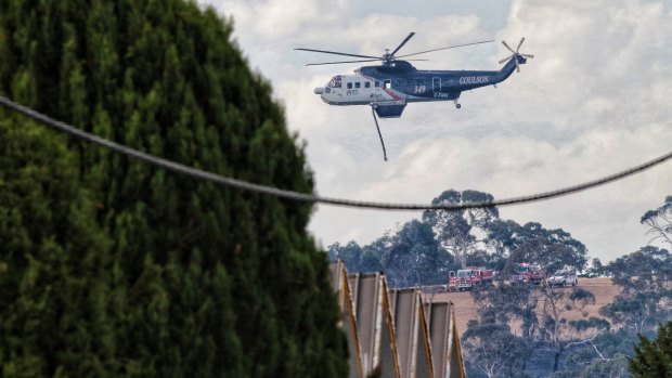 A water helicopter gets set to battle a bushfire in Hepburn Springs on Sunday.