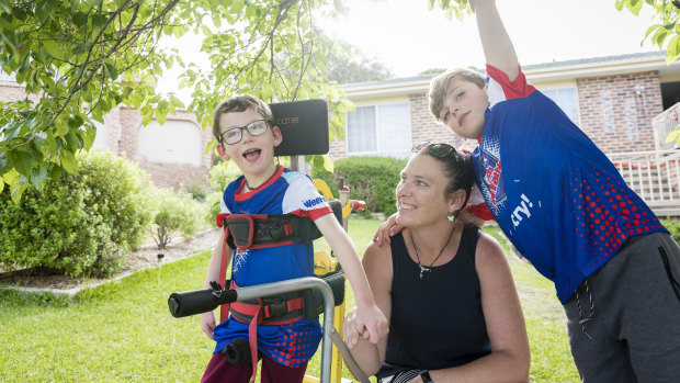 Seven-year-old Lucas Wallace, left, who is affected by cerebral palsy will participate in the Kids TRYathlon in February. By his side is mum Phyllis Wallace and nine-year-old brother Blake. 