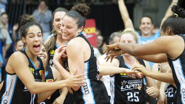 Canberra Capitals teammates cheer their co-captain Kelsey Griffin