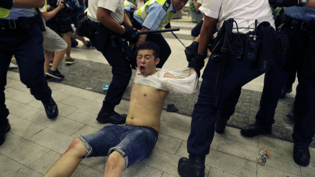 Police drag a protester away.