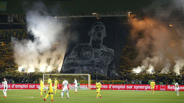 A silhouette of Emiliano Sala is shown in the crowd.