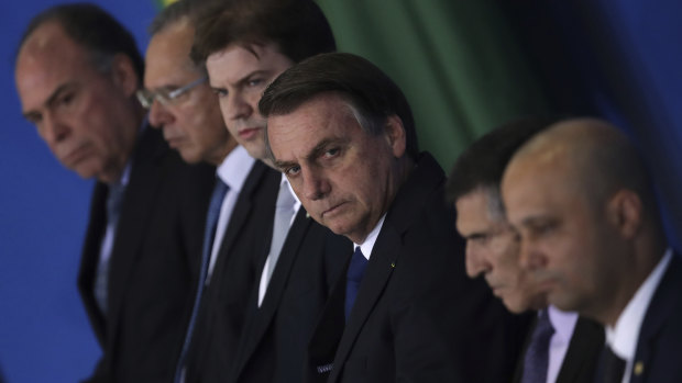 Brazil's President Jair Bolsonaro, centre, accompanied by his ministers, attends a ceremony to sign a decree on Regional Development last week.