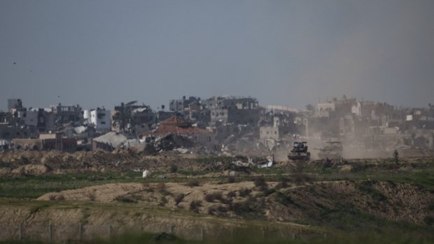 Israeli tanks move on an area at the Israeli-Gaza border, as seen from southern Israel.