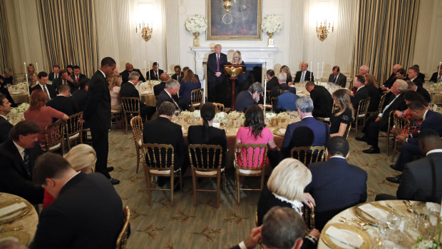 Donald Trump bows his head in prayer during the dinner with about 100 Evangelical pastors.