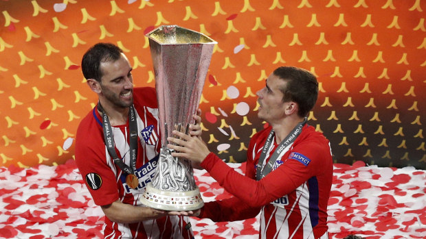 Best buds: Diego Godin and Antoine Griezmann lift the Europa League trophy.