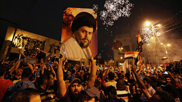 Supporters of Shiite cleric Muqtada al-Sadr, carry his image as they celebrate in Tahrir Square, Baghdad, in May. Poll results are being recounted but a different conclusion is deemed unlikely.