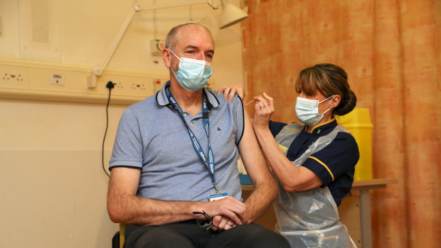 Professor Andrew Pollard, the director of the Oxford Vaccine Group, receives the jab given his status as a frontline health worker. 