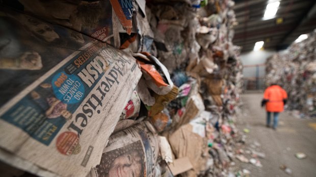 A warehouse stacked to the rafters with bales of recycling waste.