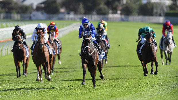 The legend grows: Hugh Bowman gestures to the crowd after winning the Queen Elizabeth Stakes on board Winx.