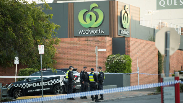 Forensic police inspect the scene in Walpole Street, Kew, where police found the attacker.