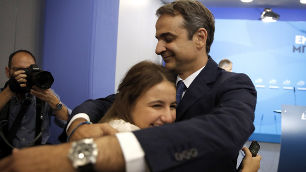 Greek opposition New Democracy conservative party leader Kyriakos Mitsotakis embraces his daughter Dafni after win in parliamentary elections.